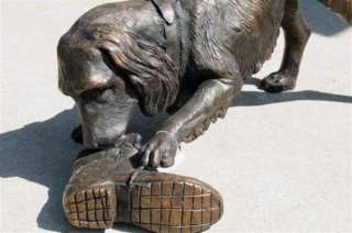 Description This is a bronze dog playing with shoe statue. This has 