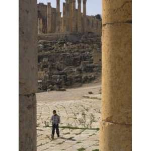 View Through Columns of Boy Walking Past, Jerash, Jordan, Middle East 