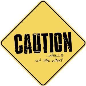  CAUTION  WELLS ON THE WAY  CROSSING SIGN