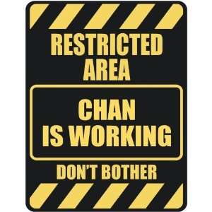   RESTRICTED AREA CHAN IS WORKING  PARKING SIGN