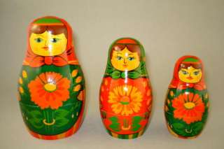   wood shirts with green blouses and red babushkas. All of the dolls
