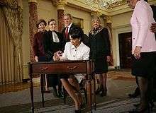 Rice signs official papers after receiving the oath of office during 